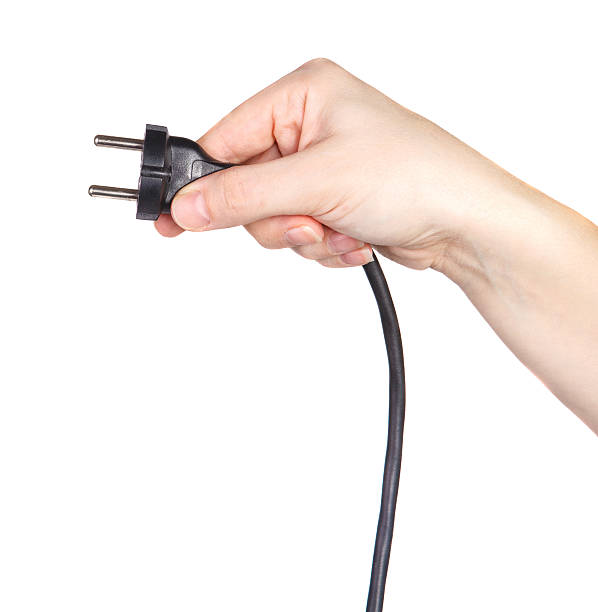 istock cable with a plug in a female hand 519650488