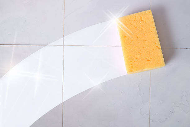 Cleaning concept trace sponge on a dirty wall tiles Cleaning concept trace yellow sponge on a dirty gray wall tiles. Horizontal composition. Impurities stock pictures, royalty-free photos & images