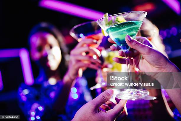 Young Friends Toasting With Drinks During Night Club Party Stock Photo - Download Image Now