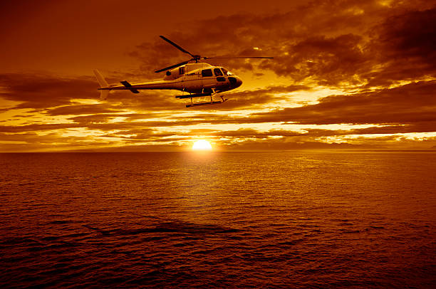 istock Helicopter flying over sea sunset 519653842