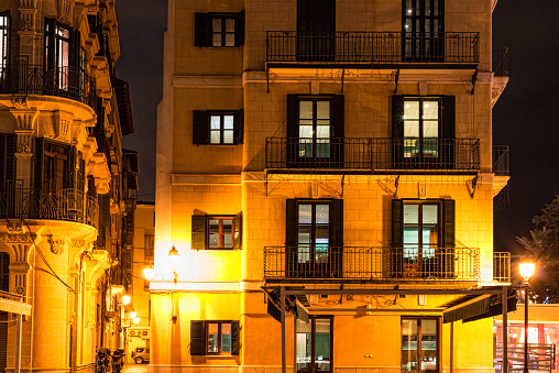 A low angle view of a building with the lights on during the night in Buffalo in New York