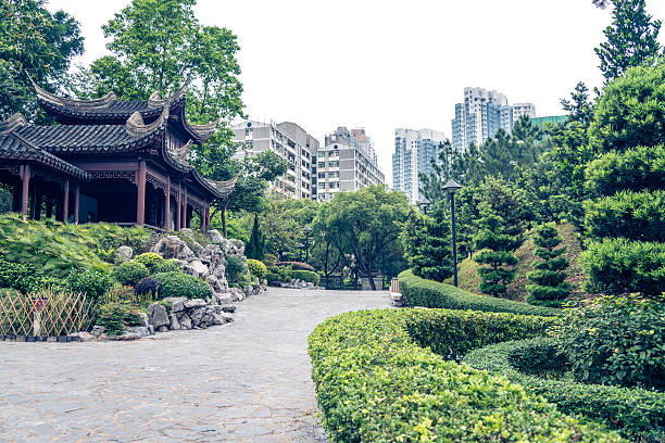 Traditional architecture in Kowloon walled City Park, Kowloon City. Modern apartments of Hong Kong in back.