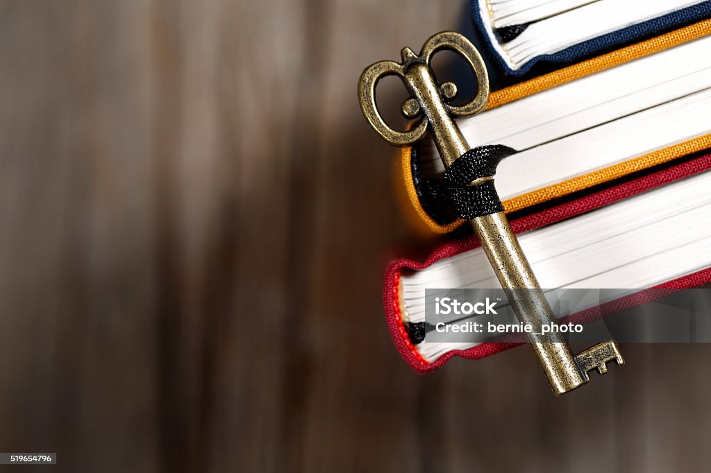 Knowledge is the key to success Retro keys and old books on the wooden table ; shot with very shallow depth of field Education Stock Photo