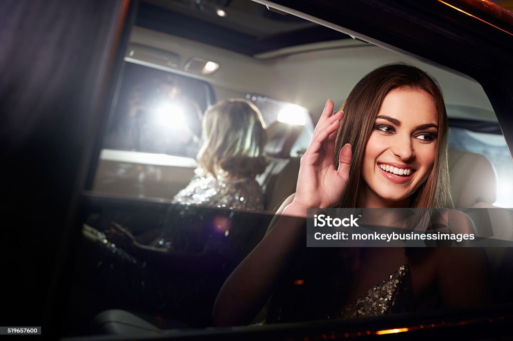 Two women in the back of a limo, photographed by paparazzi Celebrities Stock Photo