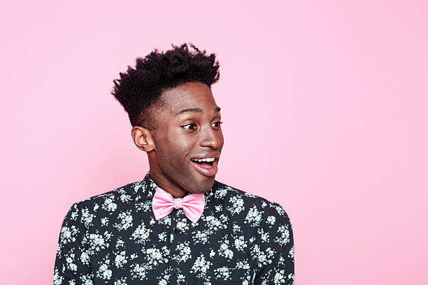 istock Excited afro american guy against pink background 519658106