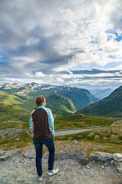 istock Young lady enjoying view of valley below 519658444