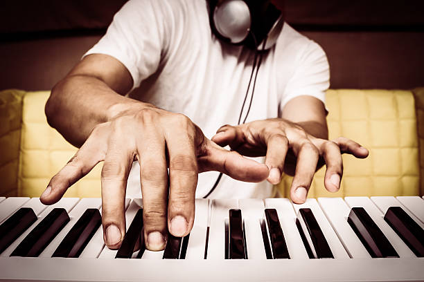 istock musician hands playing white piano 519658462