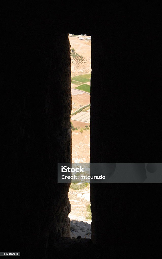 Arrowslit at a Crusaders castle Al Karak - Jordan: Crac des Moabites castle - the valley seen through an arrowslit - embrasure - Crusaders operated trade routes from Damascus to Egypt and Mecca - photo by M.Torres Architecture Stock Photo