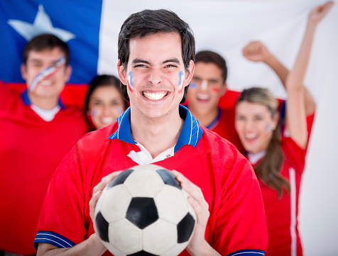 Group of Chilean soccer fans looking very happy