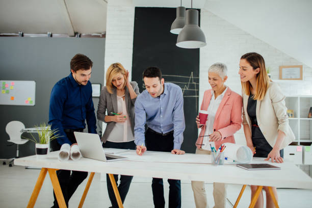 istock Architects reviewing blueprints in the office. 519661192