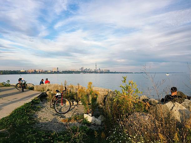 View of Toronto skyline from Sheldon Lookout Toronto, Canada - September 28, 2014: Cyclists enjoy a sunny fall day and a view of the Toronto skyline from the Sheldon Lookout where the Humber River drains into Lake Ontario. etobicoke stock pictures, royalty-free photos & images