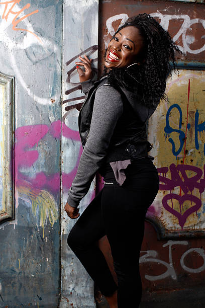 istock Happy Young Black Female Posing at Vintage Wall 519662911