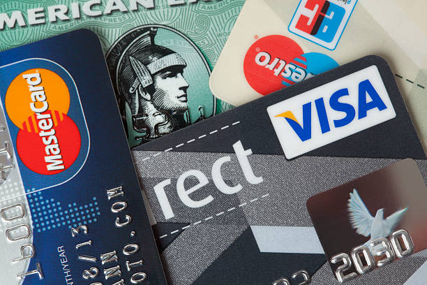 Credit and debit cards closeup Ratingen, Germany - June 21, 2011: Closeup studio shot of credit and debit cards from MasterCard, Visa, American Express. american express stock pictures, royalty-free photos & images