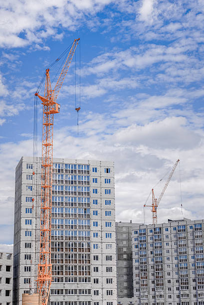 istock Hoisting crane and building of houses 519663842