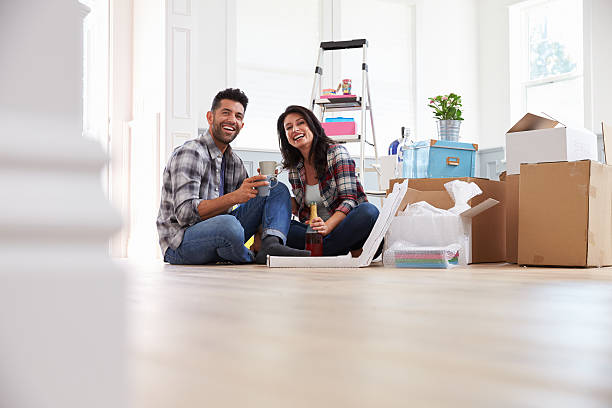 istock Couple Celebrating Moving Into New Home With Champagne 519663860