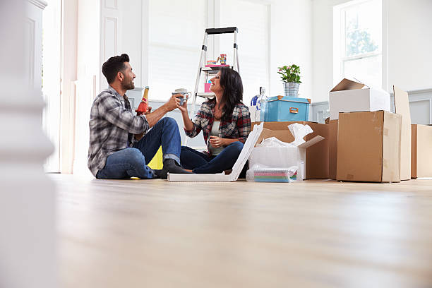 istock Couple Celebrating Moving Into New Home With Champagne 519663944