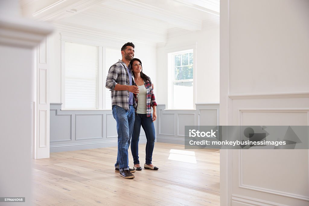 Hispanic Couple Viewing Potential New Home Couple - Relationship Stock Photo
