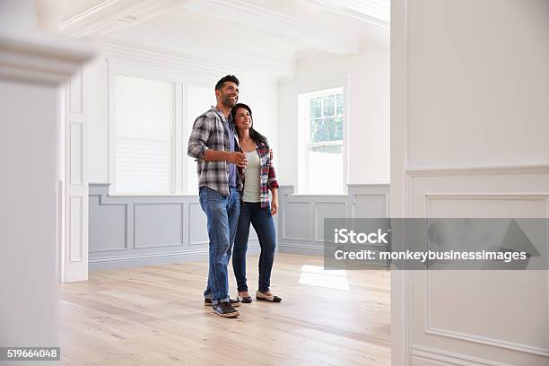 Hispanic Couple Viewing Potential New Home Stock Photo - Download Image Now - Couple - Relationship, Moving House, Home Ownership