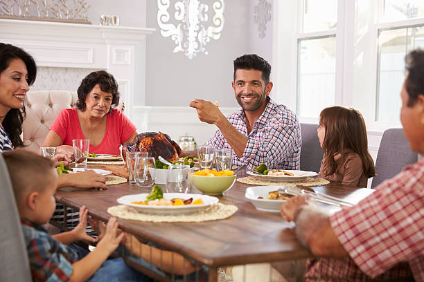 istock Extended Hispanic Family Enjoying Meal At Table 519664262