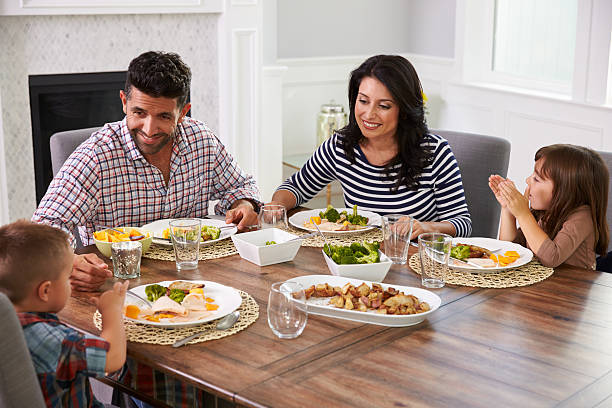 istock Hispanic Family Enjoying Meal At Table 519664270