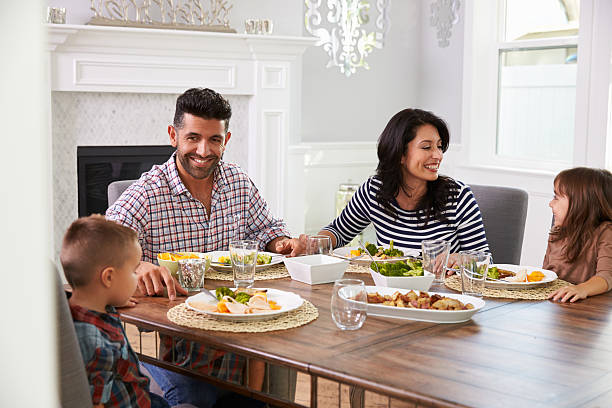 istock Hispanic Family Enjoying Meal At Table 519664320