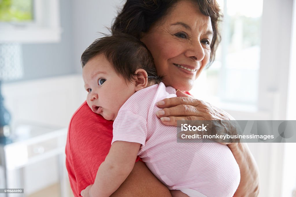 Proud Grandmother Holding Baby Granddaughter Grandmother Stock Photo