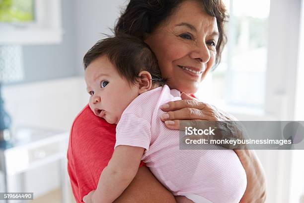 Proud Grandmother Holding Baby Granddaughter Stock Photo - Download Image Now - Grandmother, Baby - Human Age, Grandparent