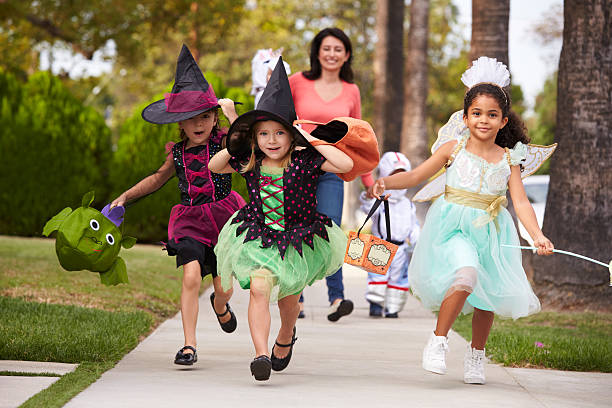 istock Parent Taking Children Trick Or Treating At Halloween 519664882