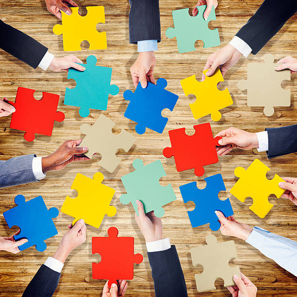 istock Group of Hands Holding Colourful Jigsaw Pieces 519666151