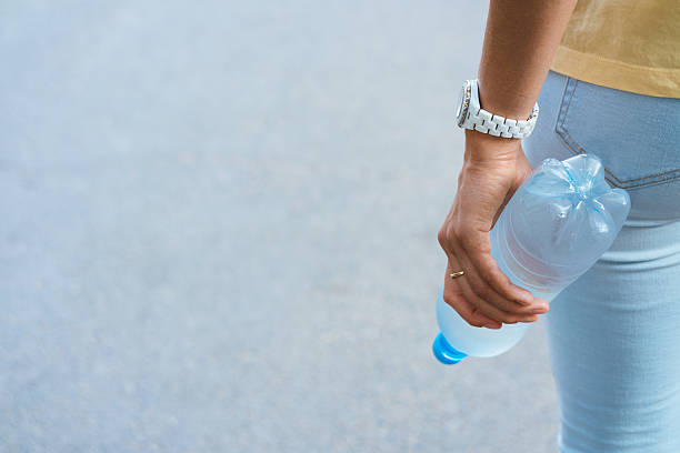 istock Female hand holding a plastic water bottle 519677960
