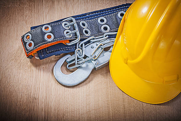 istock Construction body belt with metal carabiners chain hard hat on 519679282