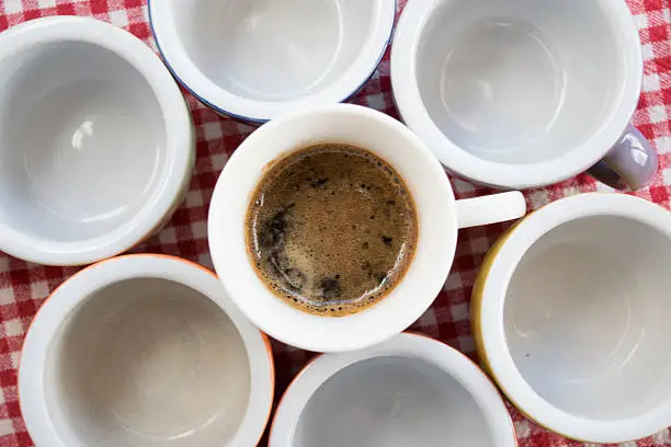 flat lay of rows of small coffee-cup with creamy espresso coffee