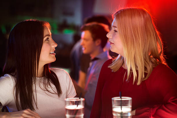 istock Two attractive girls having a intensive conversation at the bar 519679698