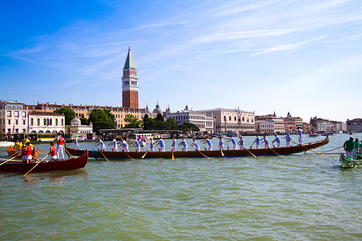 Venice, Italy - May 17, 2015: Gondoliers participate in the Festa della Sensa, an annual spring festival celebrating the symbolic marriage of Venice to the Sea. Boats and gondolas parade and race from St. Mark's Basin to the Lido.