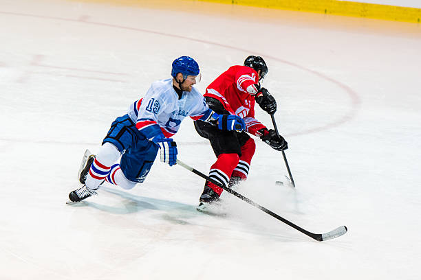 men playing ice hockey - ijshockey mannen fotos stockfoto's en -beelden