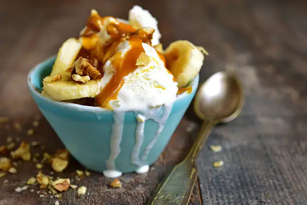 Photo of Vanilla ice cream with walnuts,banana and caramel.