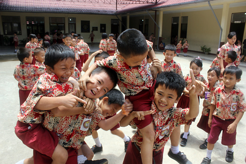 Singkawang, Indonesia - August 29, 2013: The students were playing in an elementary school in Singkawang, West Kalimantan, Indonesia, in the morning.
