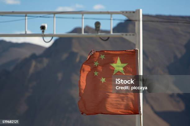 Red Flag Of China In The Wind With Defocussed Cameras Stock Photo - Download Image Now