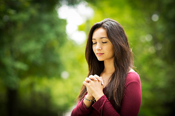 Woman praying outdoors