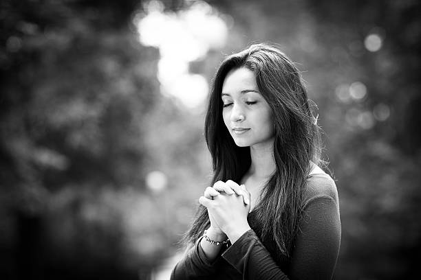 istock Woman praying outdoors 519682959