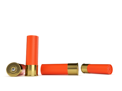 Several orange shotgun shells isolated on a white background.