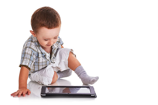 istock Baby toddler looking happy at a digital tablet 519684073