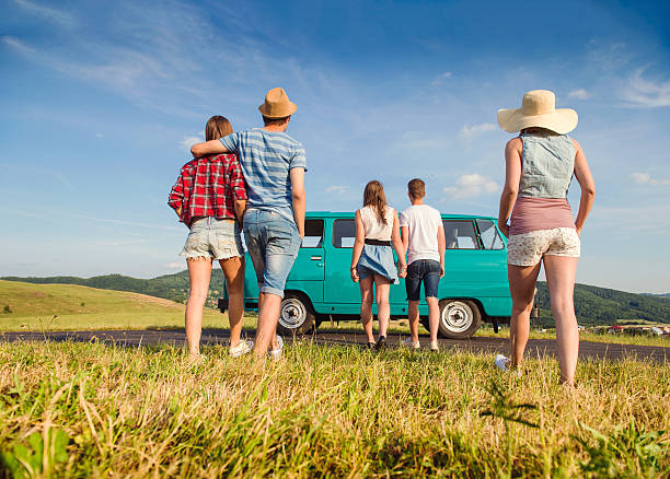 istock Couples in love, nature, blue sky, campervan, back view 519684506