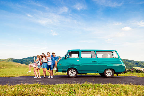 istock Young frieds with campervan, green nature and blue sky 519684850