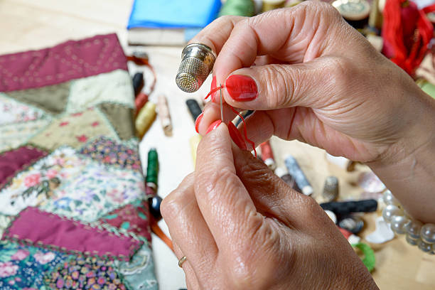 istock woman threader the wire in a needle 519684921
