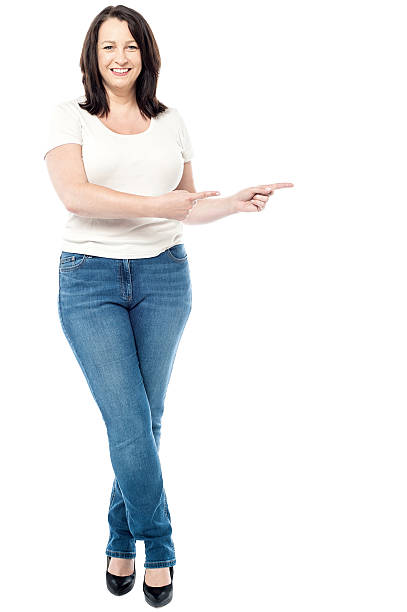 istock Happy woman pointing copy space 519684995