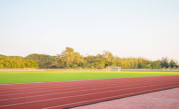 istock track running, Red treadmill in sport field with 519685020