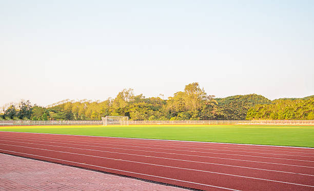 istock track running, Red treadmill in sport field with sky 519685114