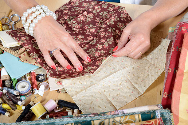 istock Close up of woman's hand sewing patchwork 519685165