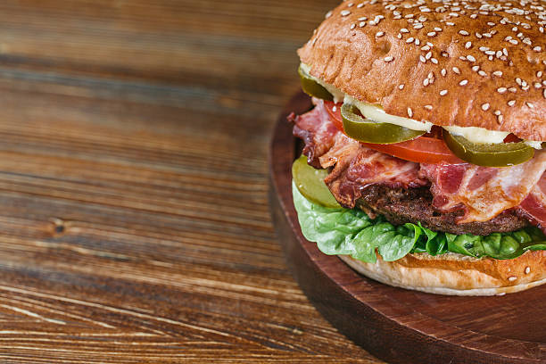 istock Close up on fresh burger on wooden table. 519685364